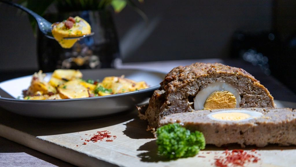 A plate of mile-high meatloaf with gravy and mashed potatoes